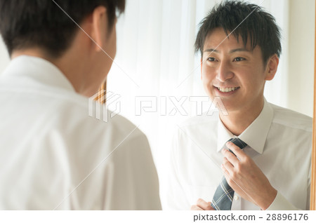 A businessman connecting a tie A businessman connecting a tie 28896176