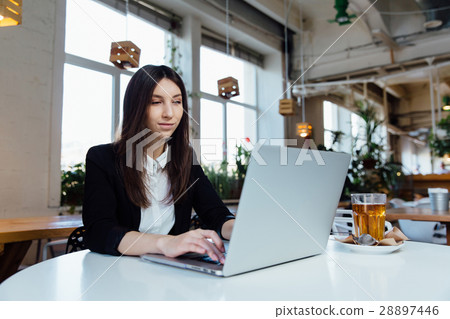 Young business woman sitting at table in cafe Young business woman sitting at table in cafe 28897446