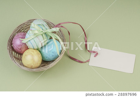 Colorful easter eggs in a basket with name tag Colorful easter eggs in a basket with name tag 28897696
