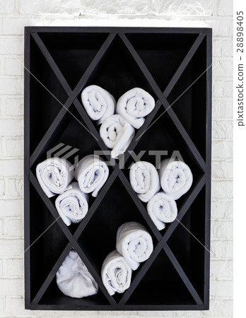 Cabinet with towels, which are twisted into a roll 28898405