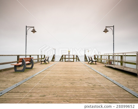 Seaside Telescope . Autumn misty morning on pier 28899652
