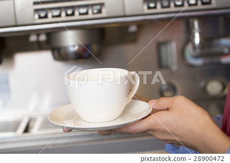 A female clerk having a coffee cup 28900472
