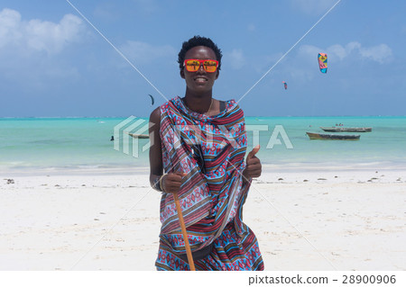 Traditonaly dressed black man on Paje beach 28900906