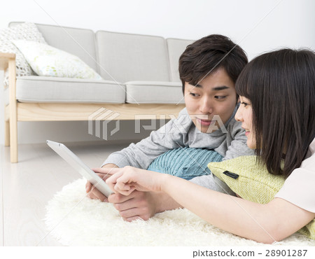 A young couple relaxing in the room A young couple relaxing in the room 28901287