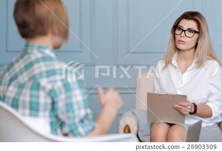 Very attentive female sitting on the sofa Very attentive female sitting on the sofa 28903309