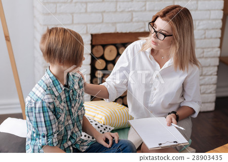 Kind psychologist cheering up her little patient 28903435