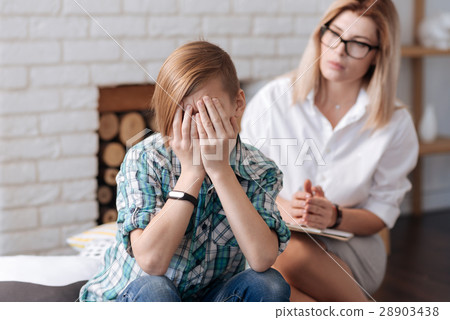 Upset teenager meeting with his psychologist 28903438