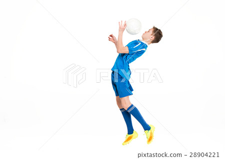 Young boy with soccer ball doing flying kick 28904221