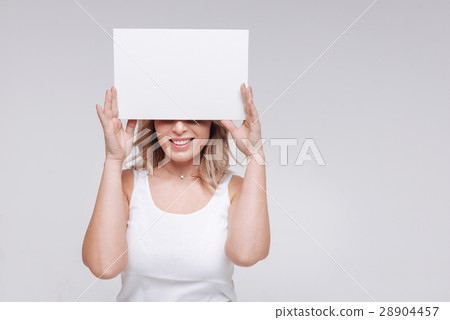 Lively joyful lady covering her eyes 28904457