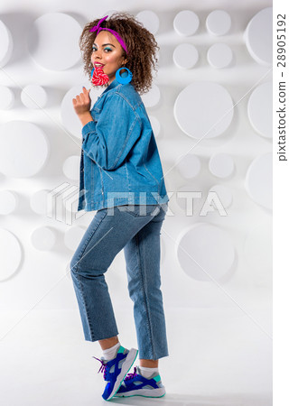 Smiling young woman tasting lollipop 28905192