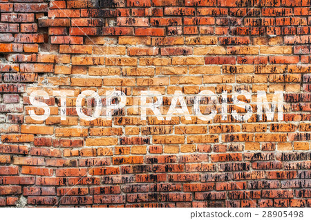 Text STOP RACISM on stained old orange brick wall 28905498