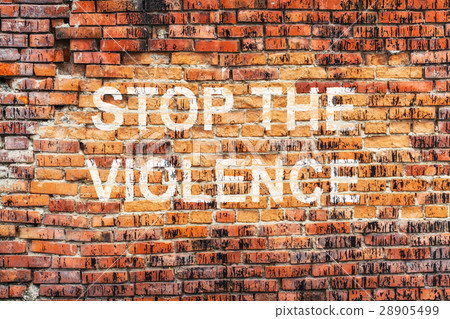 Text STOP VIOLENCE on stained orange brick wall Text STOP VIOLENCE on stained orange brick wall 28905499