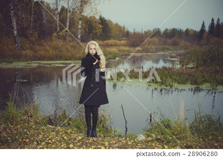 Beautiful elegant woman in a black coat 28906280