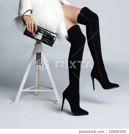 Slender female legs in boots stockings Slender female legs in boots stockings 28906300