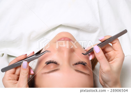 Eyelash Extension Procedure. Woman Eye with Long Eyelash Extension Procedure. Woman Eye with Long 28906504