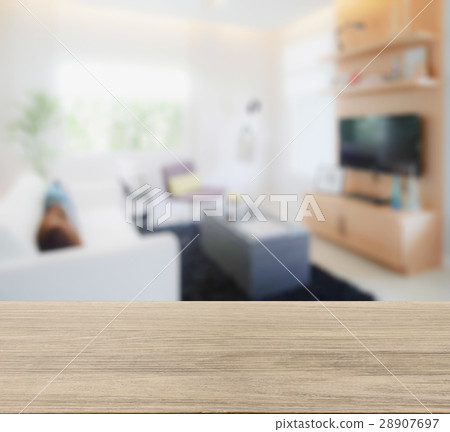 wooden table top with blur of modern living room 28907697