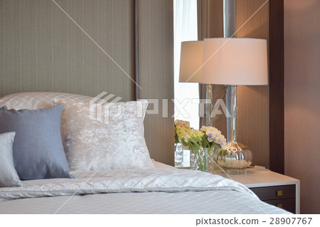 Classic bedroom with pillows and reading lamp 28907767