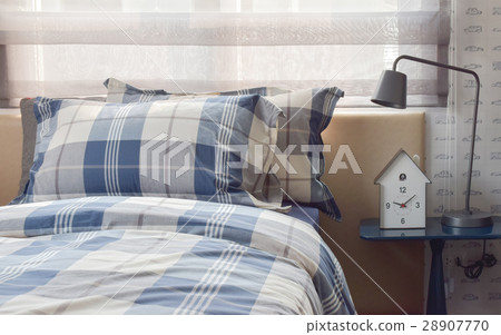 Cozy bedroom with pillows and reading lamp Cozy bedroom with pillows and reading lamp 28907770