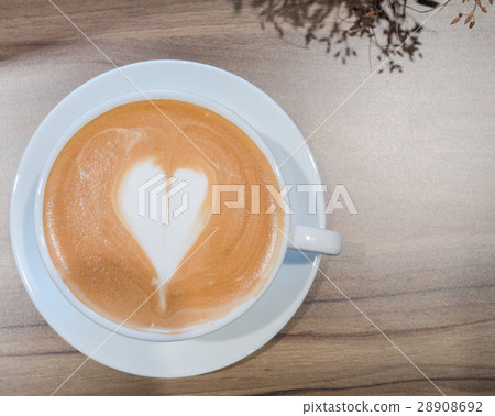 Hot coffee in white cup on table in top view Hot coffee in white cup on table in top view 28908692
