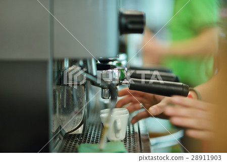 prepares espresso in his coffee shop, close-up prepares espresso in his coffee shop, close-up 28911903
