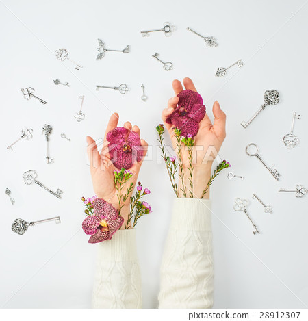 Conceptual photo. Hands with flowers and keys. Conceptual photo. Hands with flowers and keys. 28912307