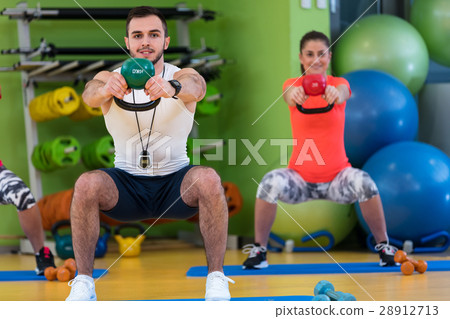 Kettlebells swing exercise man and woman workout Kettlebells swing exercise man and woman workout 28912713