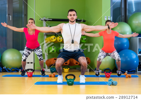 Kettlebells swing exercise man and woman workout Kettlebells swing exercise man and woman workout 28912714