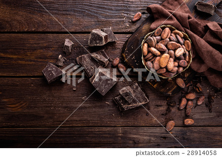 Cocoa beans and chocolate on wooden background 28914058