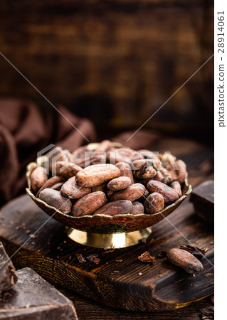 Cocoa beans and chocolate on wooden background 28914061