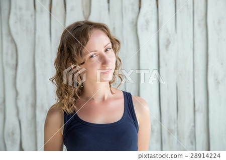 Beautiful young woman is looking at camera and smiling Beautiful young woman is looking at camera and smiling 28914224