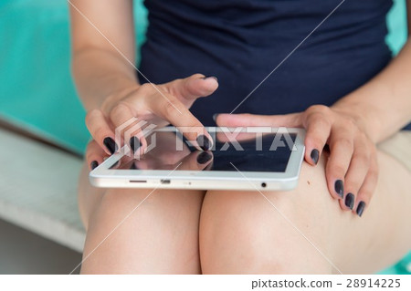 Close-up woman hands using digital tablet computer. Close-up woman hands using digital tablet computer. 28914225