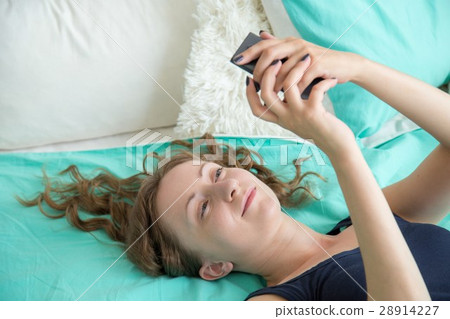 Woman using smartphone Woman using smartphone 28914227
