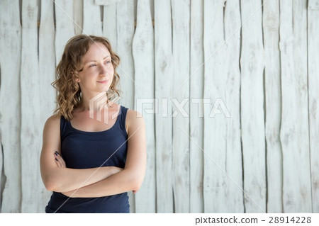 Beautiful young woman is looking at camera and smiling Beautiful young woman is looking at camera and smiling 28914228