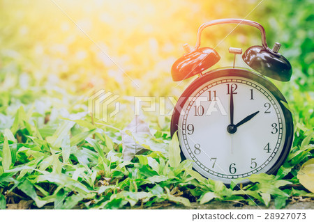 2 o'clock retro clock in the garden grass field. 2 o'clock retro clock in the garden grass field. 28927073