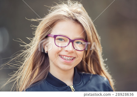 Girl with glasses. Girl with teeth braces. Girl with glasses. Girl with teeth braces. 28928636