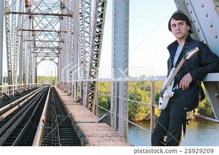 Man with an electric guitar in the industrial 28929209