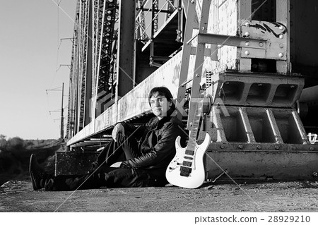 man with an electric guitar in the industrial 28929210