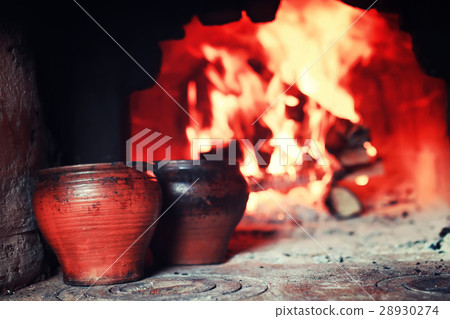 pot in the oven and oven fork 28930274