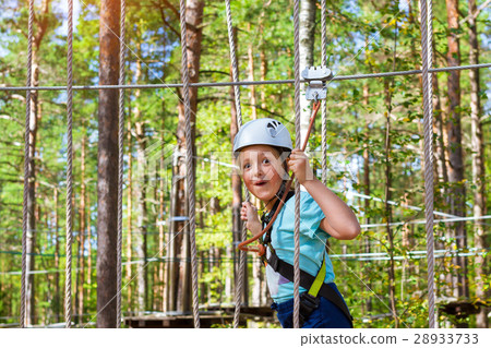 Girl on hinged trail in extreme rope Park 28933733