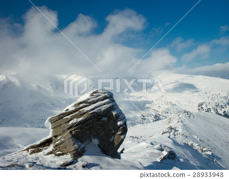 rock covered with snow and fog 28933948