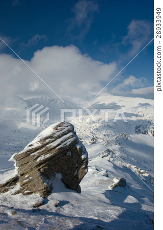 rock covered with snow and fog 28933949