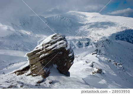 rock covered with snow and fog 28933950