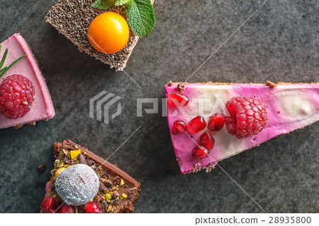 raw vegan cakes with fruit and seeds, decorated 28935800