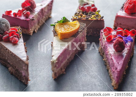 raw vegan cakes with fruit and seeds, decorated 28935802