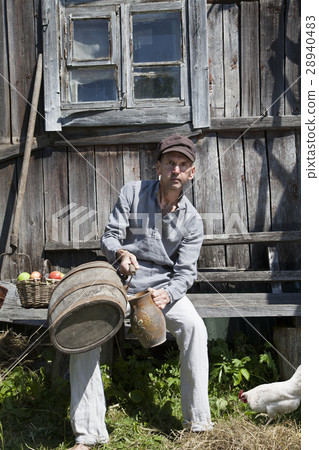 Male peasant pouring some wine in a jug 28940483