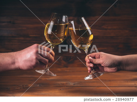 Hands of man and woman cheering with glasses  28940977