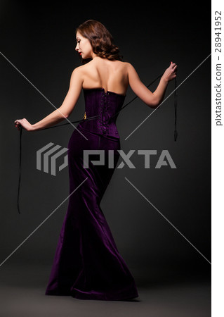 Woman posing in purple dress Woman posing in purple dress 28941952