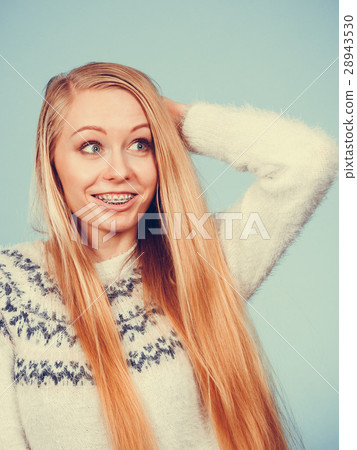 Happy woman showing her braces on teeth Happy woman showing her braces on teeth 28943530