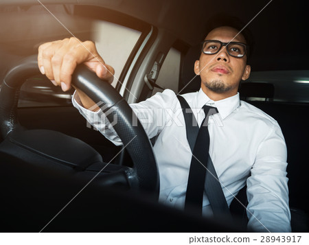 Asian businessman  driving a car. 28943917