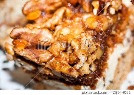 Walnut toffee cake with white cream close up Walnut toffee cake with white cream close up 28944031